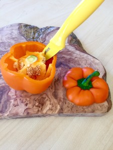 Coring an orange bell pepper