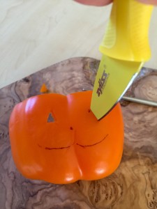 Carving an orange bell pepper