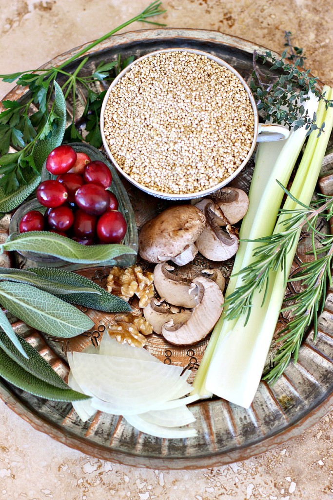 Thanksgiving Quinoa ingredients of quinoa, fresh savory herbs, parsley, sage, rosemary and thyme, onions, celery, walnuts, mushrooms and cranberries