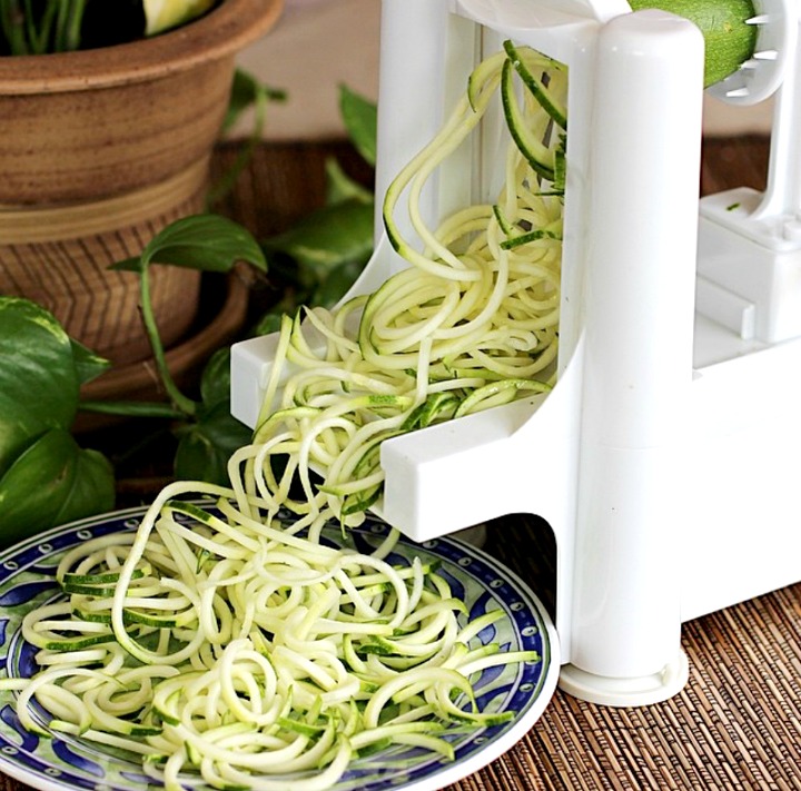 White plastic spiralizer machine making long strands of zucchini noodles