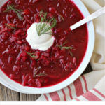 Pinterest graphic white bowl with red beet borscht topped with a white dollop of sour cream and a sprig of fresh dill