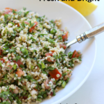 Pinterest graphic with white bowl of tabouli with a silver fork in it and lemon and parsley in the background